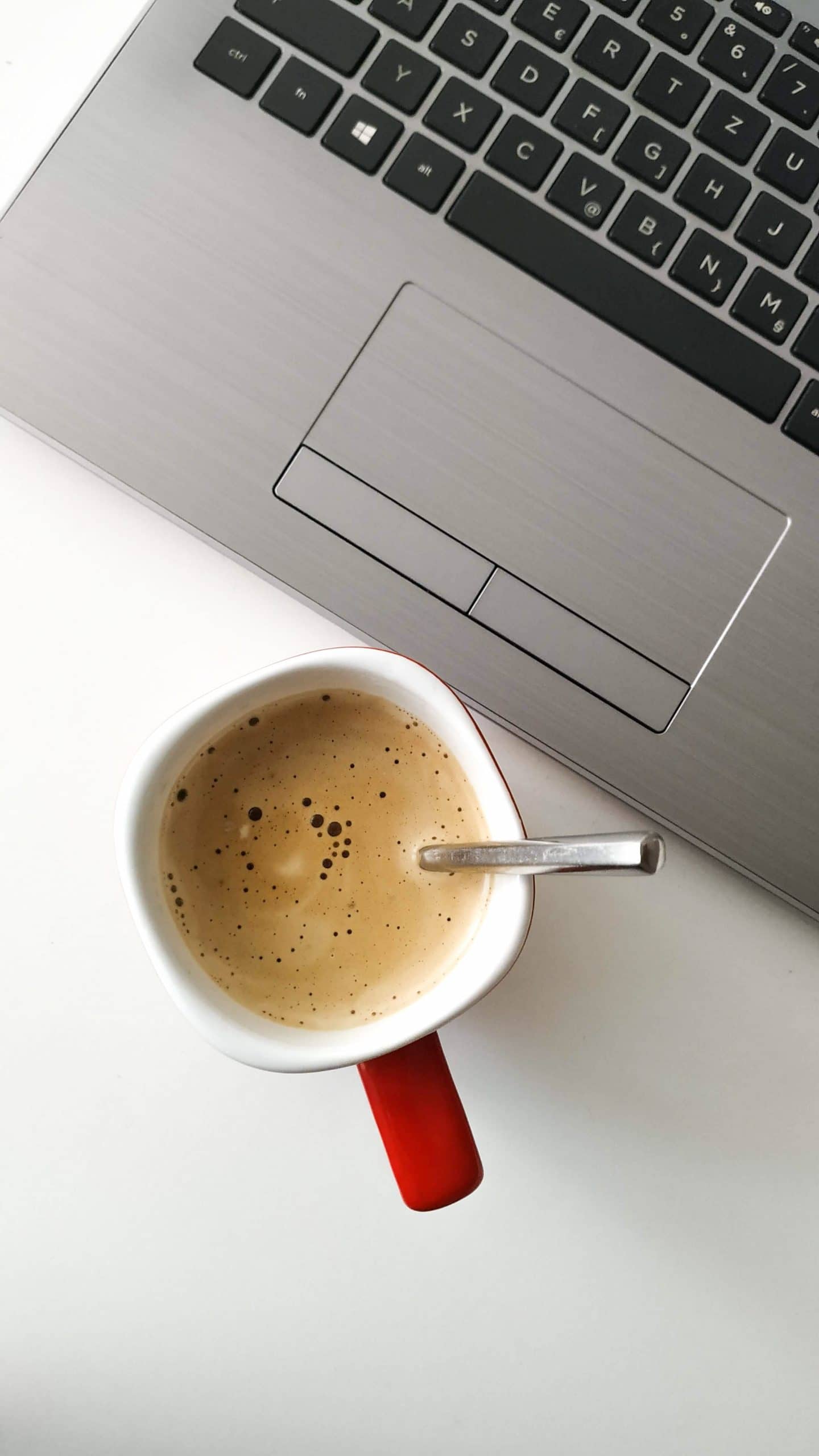 coffee filled mug by laptop